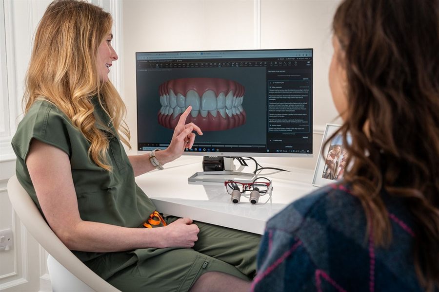 Dentist explaining a digital dental scan to a patient on a monitor